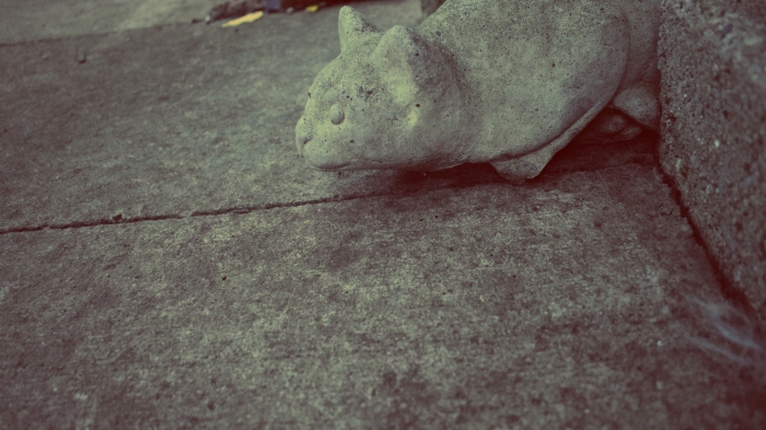 a cement cat on concrete - thetemenosjournal.com